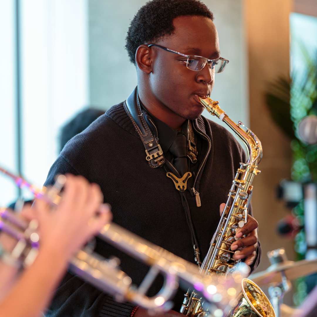 Student in black shirt playing saxophone