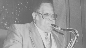 Black and white image of man playing saxophone